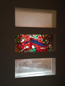 a stained glass window on a wall in a room at CasaNova in Bad Windsheim