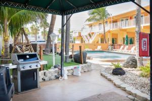 a backyard with a grill and a swimming pool at Windjammer Resort and Beach Club in Fort Lauderdale