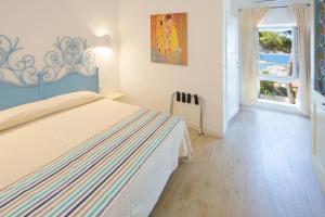 Postel nebo postele na pokoji v ubytování Grand Hotel Palau