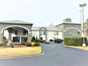 a building with a car parked in front of it at Country Inn & Suites by Radisson, Greenville, NC in Winterville