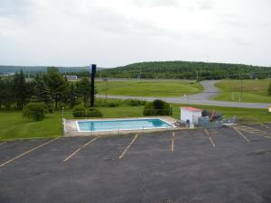 an empty parking lot with a swimming pool in it at Rodeway Inn in Woodstock