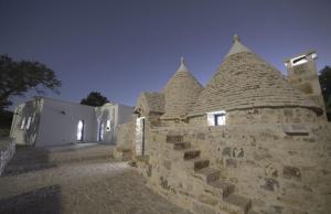 a stone wall with two towers on top of it at Mille e un Trullo in Ostuni
