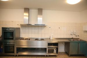 a kitchen with a sink and a stove top oven at Twinhof in Hamburg +24 photos