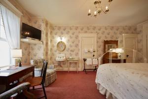 a hotel room with a large bed and a large window at The Red Lion Inn in Stockbridge