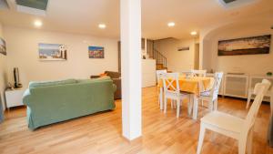 a living room and dining room with a couch and a table at Casa Vacanze Vittoria in Ravello