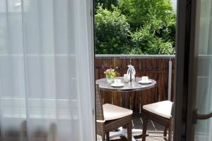 a table and chairs on a patio with a window at AVITAL Resort in Winterberg