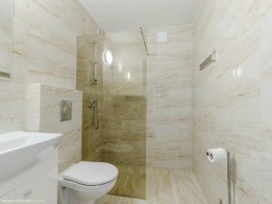 a white bathroom with a toilet and a shower at Przystań Jagoda - pokoje i domki in Ostrowo +51 photos