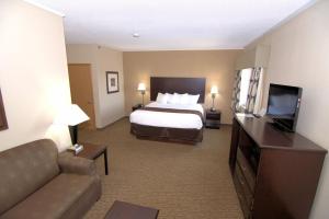 a hotel room with a bed and a flat screen tv at Rock Island Inn & Suites in Atlantic