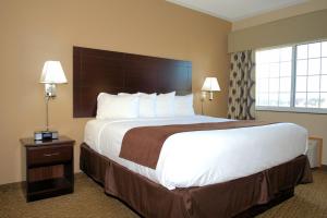 a hotel room with a large bed and a window at Rock Island Inn & Suites in Atlantic