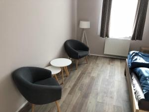 a living room with two chairs and a couch at Apartmán Marcello in Trenčianske Teplice