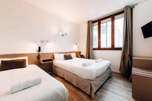 Postel nebo postele na pokoji v ubytování Hôtel Alizé