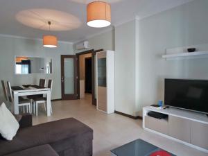 a living room with a couch and a television and a table at B03 - Luxury 2 Bed Lagos Marina in Lagos