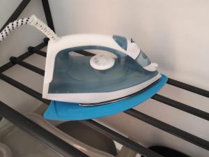 a blue and white telephone sitting on a shelf at Marina's Rooms in Larnaca