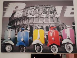 a painting of vespas in front of the coliseum at Marina's Rooms in Larnaca
