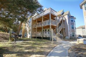 a building with a large deck on the side of it at Barrier Island Station in Duck