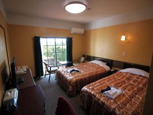 Kashikojima Hotel Bay Garden客房内的一张或多张床位