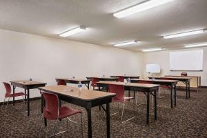 a classroom with tables and chairs and a whiteboard at Travelodge by Wyndham Morrill in Morrill
