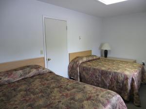 سرير أو أسرّة في غرفة في Lazy J Motel