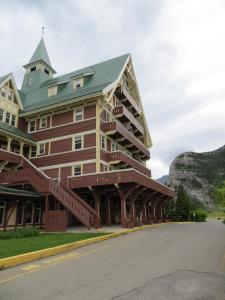a large wooden building with a green roof at Prince of Wales Hotel in Waterton Park