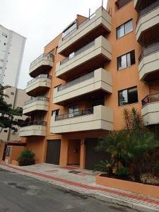 a large apartment building with balconies on a city street at Vista para o Mar a 180 m da Praia in Meia Praia