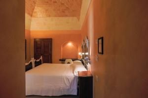 Postel nebo postele na pokoji v ubytování Hotel Casino Ridola