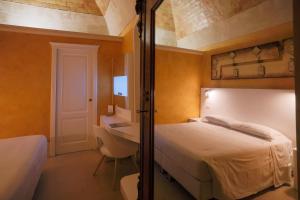Postel nebo postele na pokoji v ubytování Hotel Casino Ridola