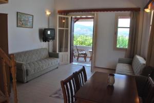 a living room with a table and a couch and a television at Troyan Hill Apartments in Petra