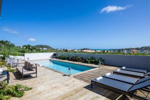 a swimming pool on the roof of a house at Villa Jwi Lavi Boutique Hotel in Cul de Sac