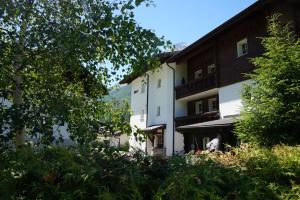 a large white building with trees in front of it at Art Oase - Lenzspitze in Saas-Grund