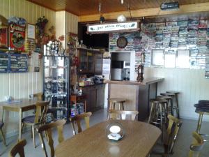 a restaurant with wooden tables and chairs and a kitchen at Zur alten Eiche in Stepenitz +39 photos