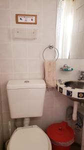 a bathroom with a white toilet and a sink at ETERNO SOL Loft Andino in Humahuaca