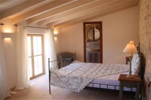 een slaapkamer met een bed en een raam bij Living Casa Luna in Santanyi