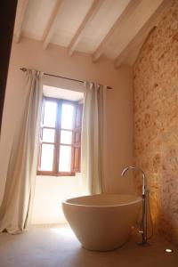 a bathroom with a large tub in front of a window at Living Casa Luna in Santanyi +11 photos