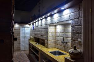 a bathroom with a sink and a brick wall at Riad Razoli Sidi Daoui in Rabat +44 photos
