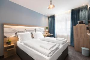 Postel nebo postele na pokoji v ubytování Hotel dasPaul
