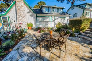 un patio con tavolo e sedie di fronte a una casa di Carmel Green Lantern Inn a Carmel