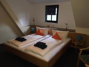 a bedroom with a bed with two pillows on it at Altes Bierhaus in Arzbach