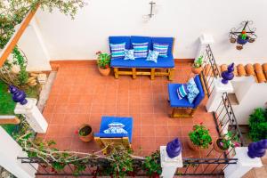 an overhead view of a patio with blue chairs and potted plants at El Jardin De Su Merced B&B in Sucre