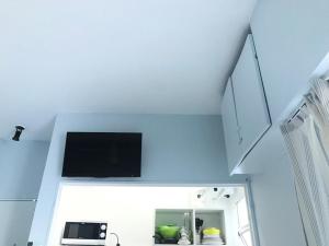 a living room with a tv on a white wall at Apartamentos Paraguay Soleado Excelente Ubicacion in Buenos Aires