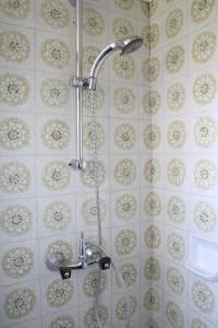 een douche met een kraan in de badkamer bij Ferienwohnungen Benedikt in Villach