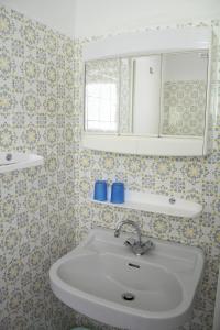 a bathroom with a sink and a mirror at Ferienwohnungen Benedikt in Villach +22 photos