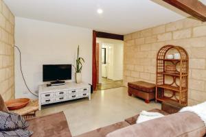 A television and/or entertainment center at By the Sea Margaret River