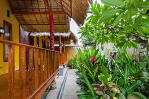 a balcony of a building with a bunch of plants at Rama Homestay in Nusa Penida