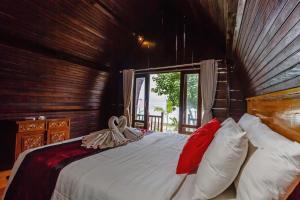 Ένα ή περισσότερα κρεβάτια σε δωμάτιο στο Rama Homestay