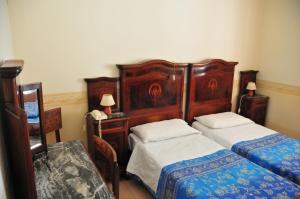 Łóżko lub łóżka w pokoju w obiekcie Locanda Sant'Anna Hotel