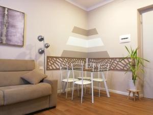 a living room with a table and chairs and a couch at Bixio Suites in La Spezia