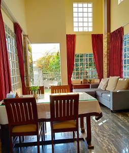 a living room with a table and chairs and a couch at KOL House in Phnom Penh