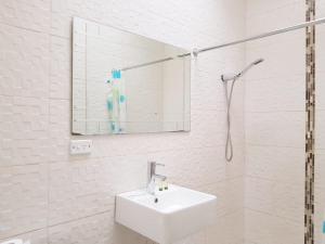 a white bathroom with a sink and a mirror at Perth City Motel in Perth +53 photos