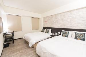 Voodi või voodid majutusasutuse Home Rest Hotel toas