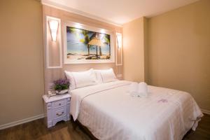 Postel nebo postele na pokoji v ubytování Lavender Inn USJ